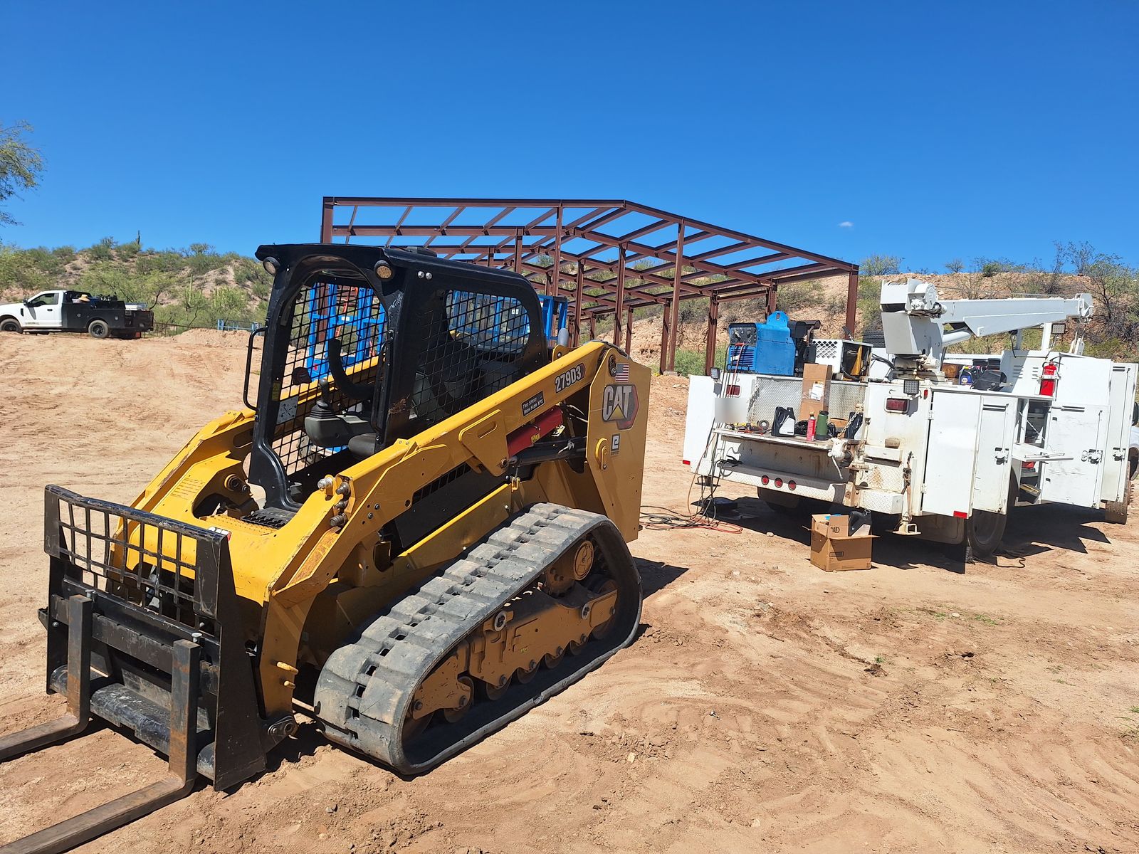 CAT skid steer and service truck