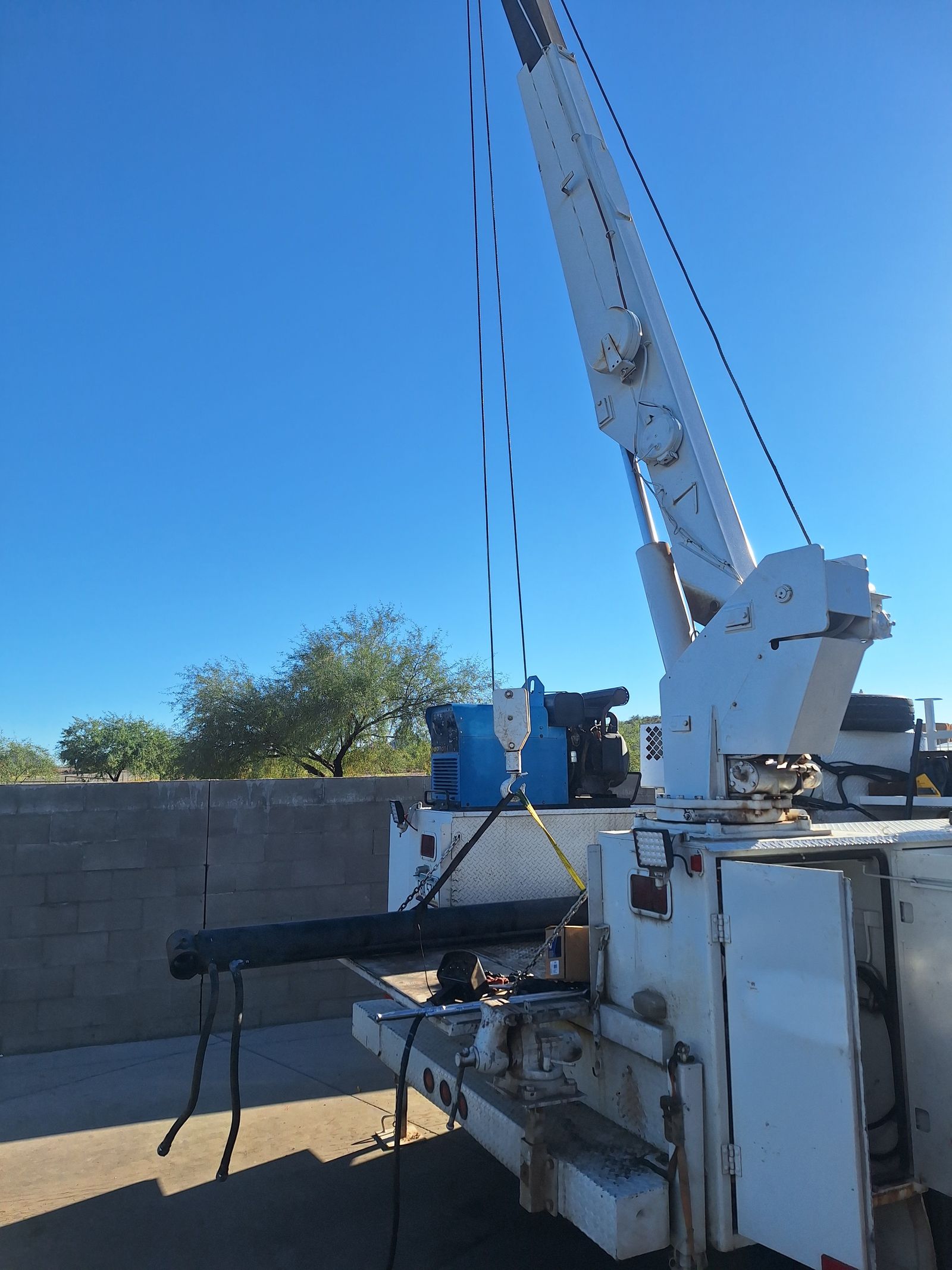Service truck crane lifting a part